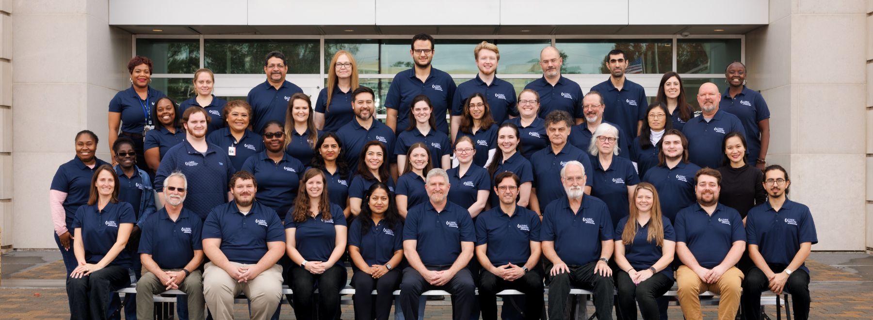 Group shot of department members in front of the School of Medicine.